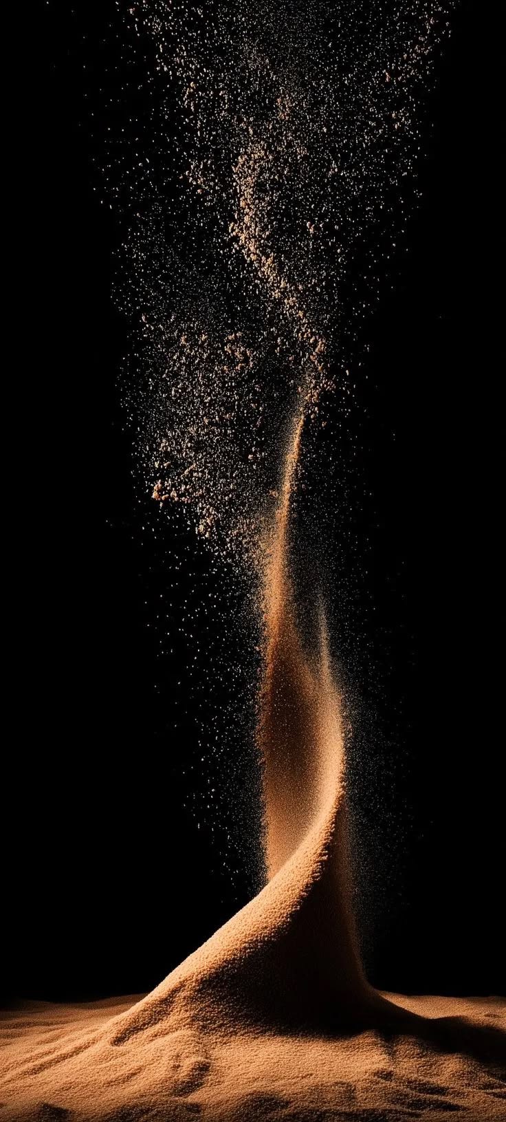 Warm light drawing a rising column out of falling sand